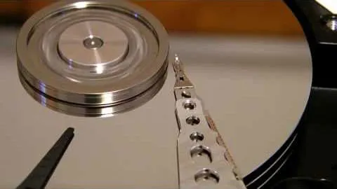 An opened hard drive with visible damage